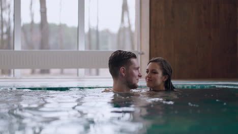 man-and-woman-are-swimming-together-in-swimming-pool-of-modern-thermal-bath-relax-and-rest-in-weekend
